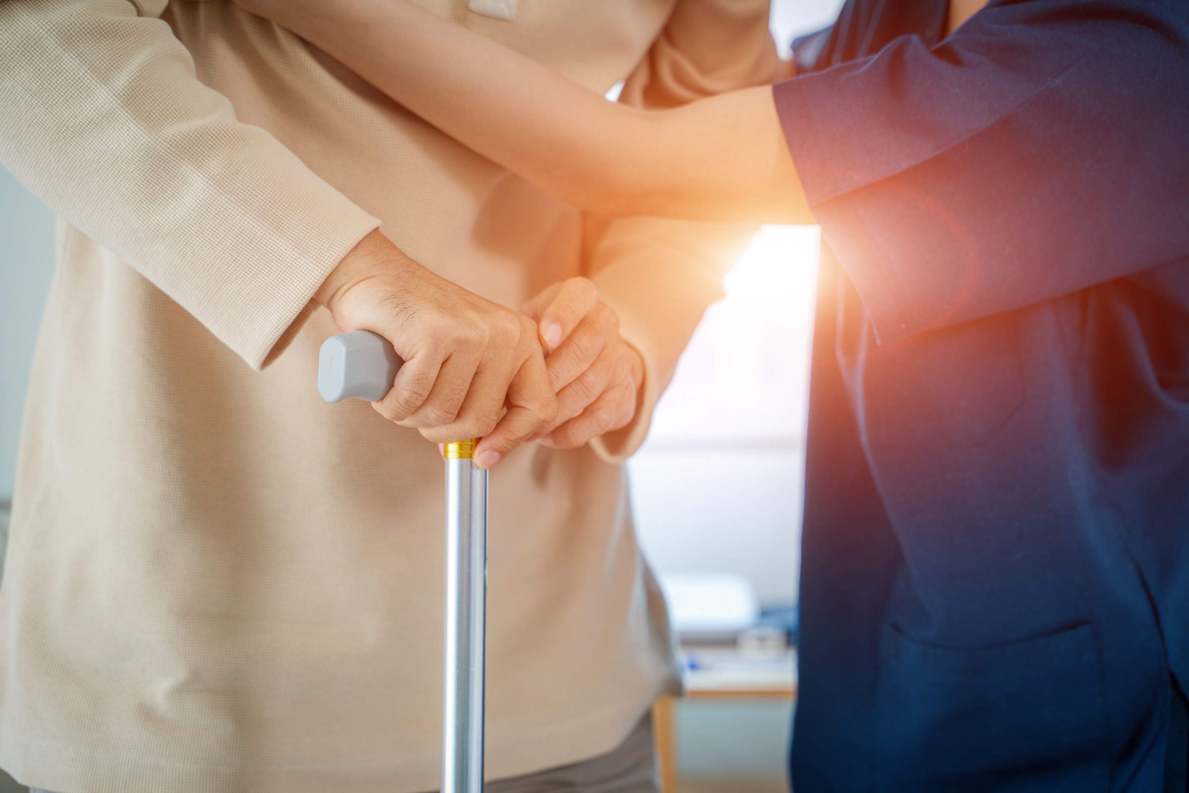 Nurse helps senior man practice walking at nursing home,Caregive